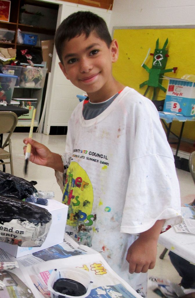 A happy 2017 camper works on a papier-mache project. (HCAC photo)