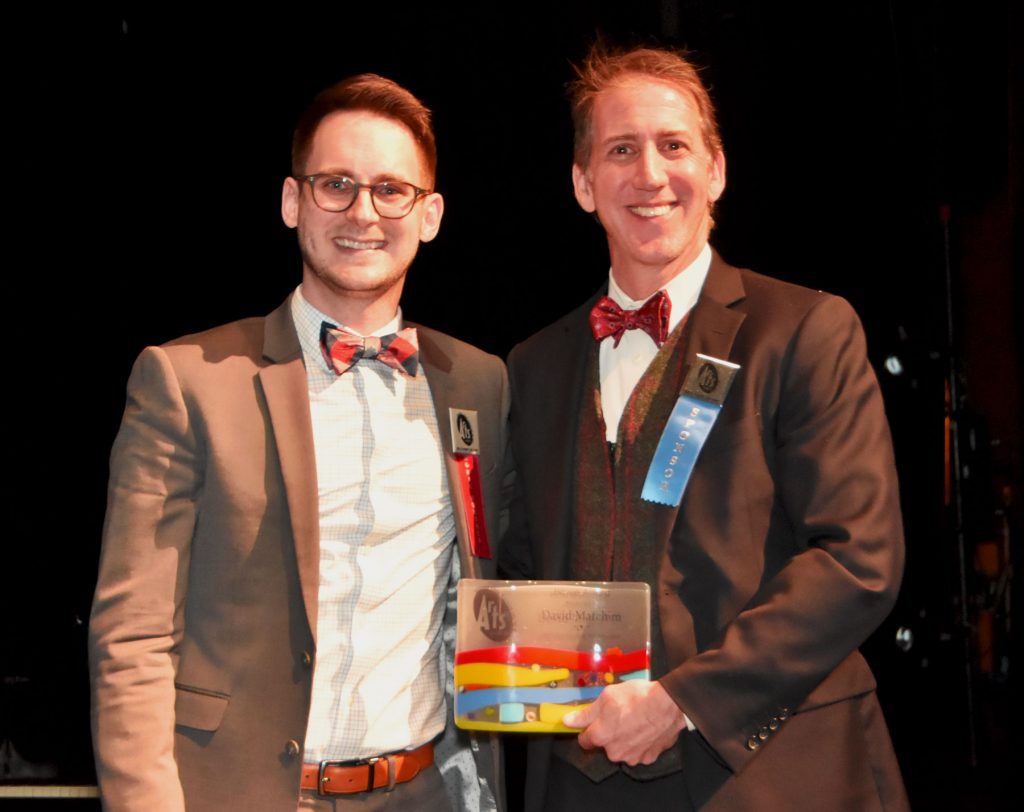 David Matchim, Band Director at Centennial High School, accepts the 2018 Howie Award for Outstanding Arts Educator from David Nitkin, Chief of Staff at Howard County General Hospital (HCAC photo)