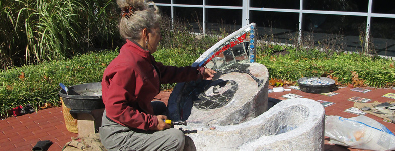 Artist Susan Stockman works on her redesign of HCAC's Benchmark sculpture (HCAC photo)