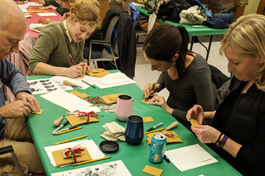 Holiday Printmaking workshop participants carve their designs (HCAC photo)