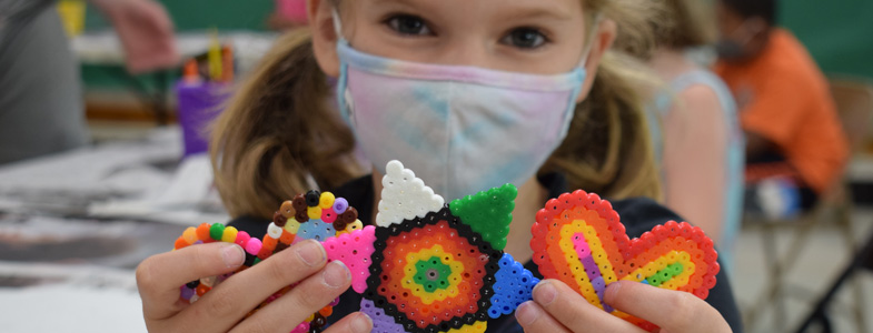 A 2021 summer camper displays her creations (HCAC photo)