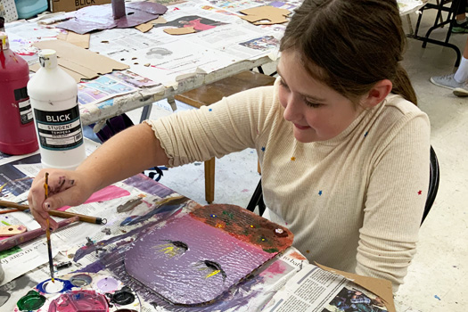 A student works on a painting project (HCAC photo)