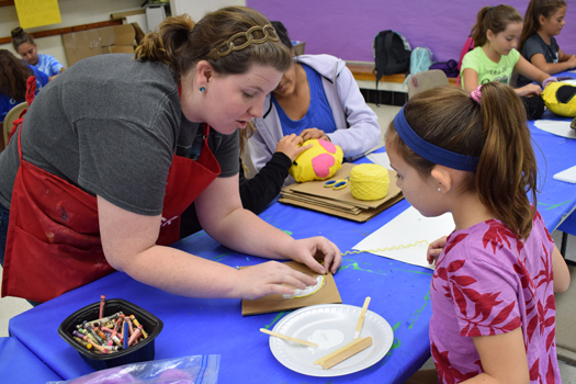 Instructor Katelyn Smith works with a student (HCAC photo)  