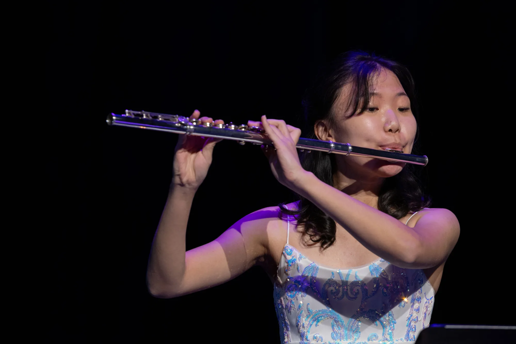 Angelina Lim playing the flute at the Celebration.