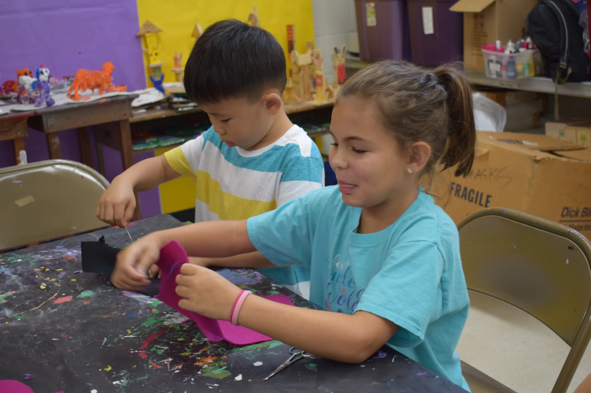 Campers work on cutting shapes out of foam
