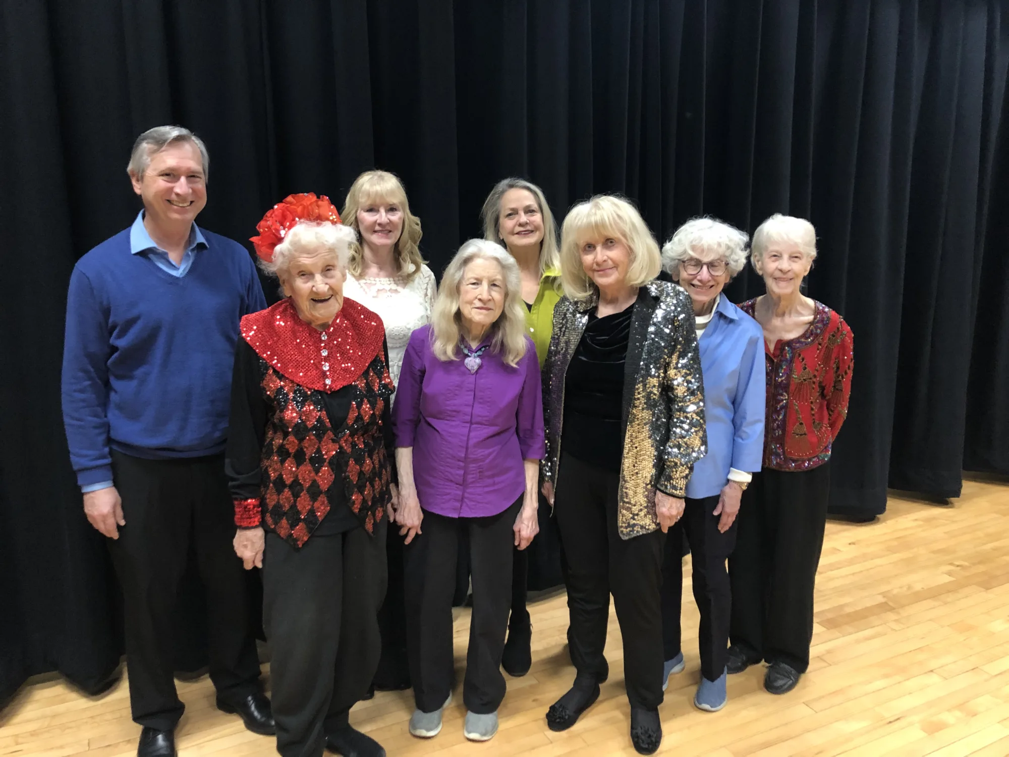Eight members of the Fabulous 50+ Players stand for a group photo.
