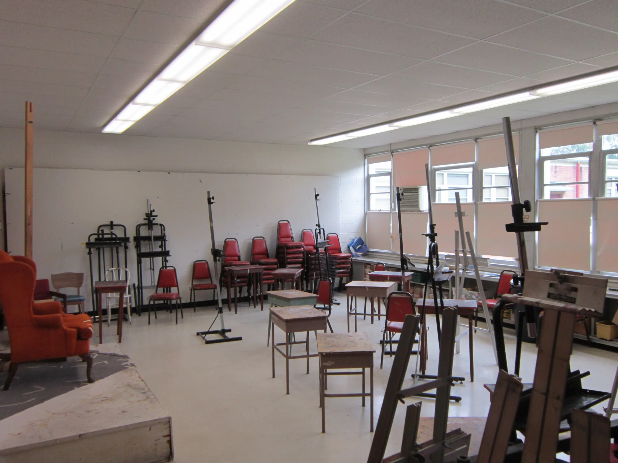 Classroom with tables, chairs, and easels