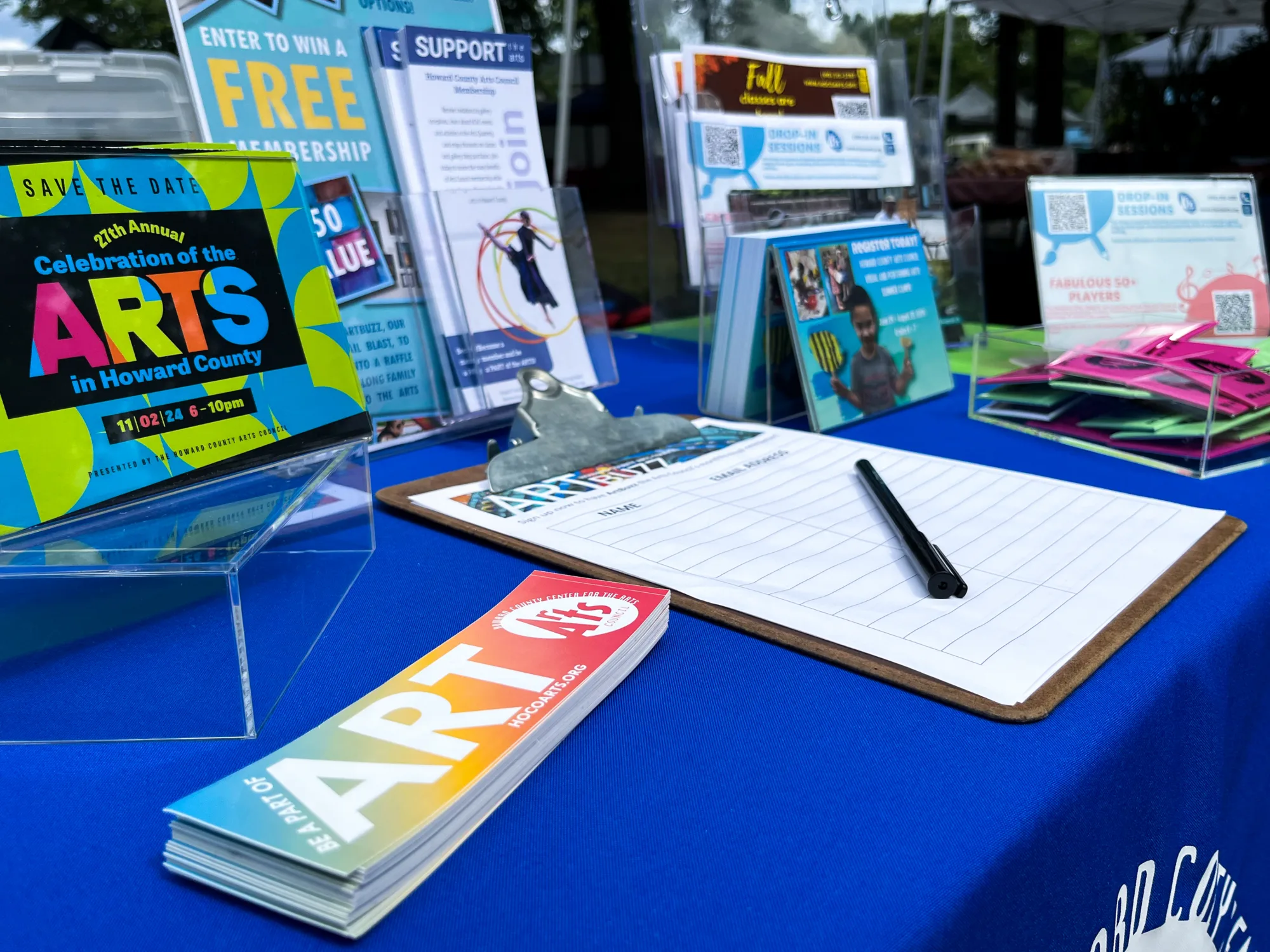 A blue table filled with Arts Council brochures