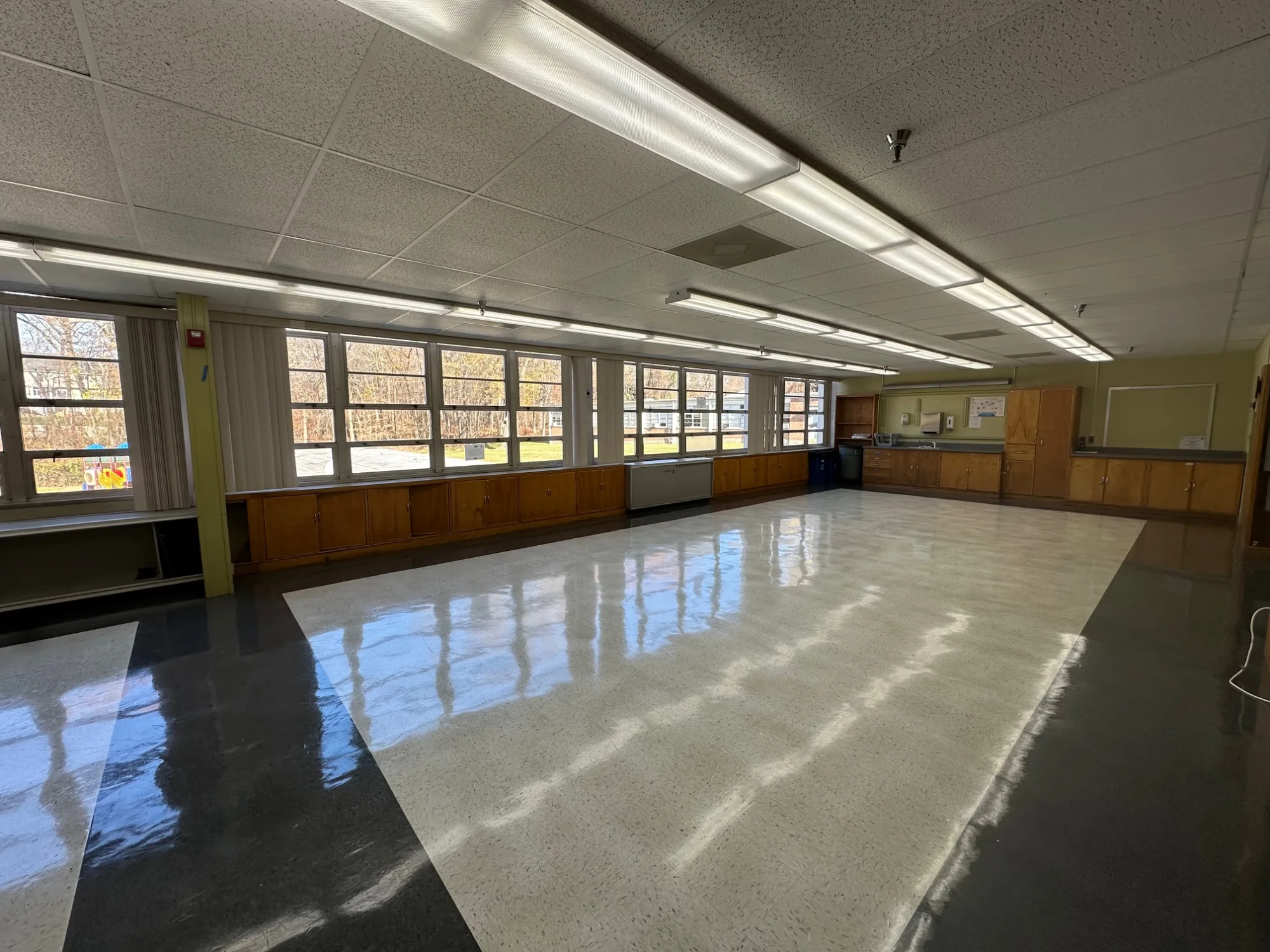Empty Conference Room with shiny floors and windows to the left