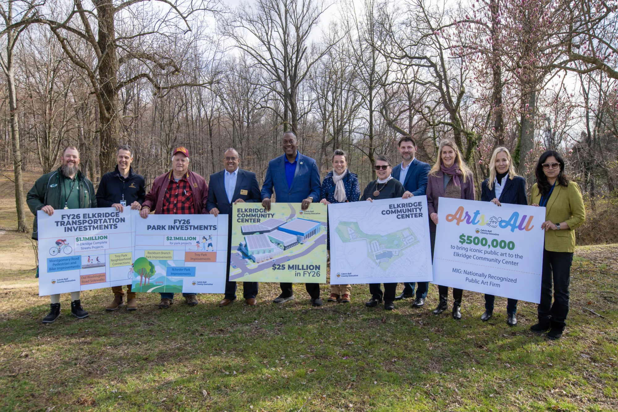 A group of community members holding boards with project information
