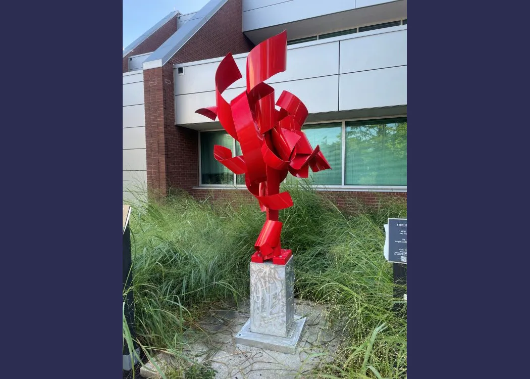 a ribbon-like metal sculpture that twists toward the sky
