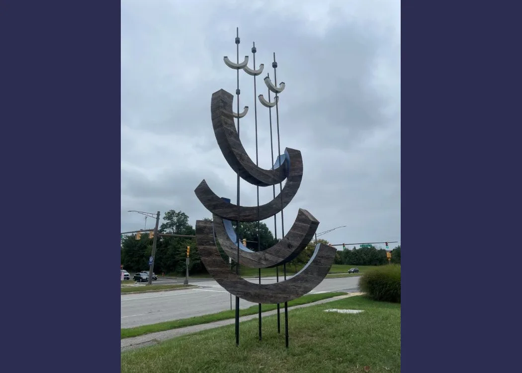 a large sculpture using C shapes in an abstract way to represent waves and birds