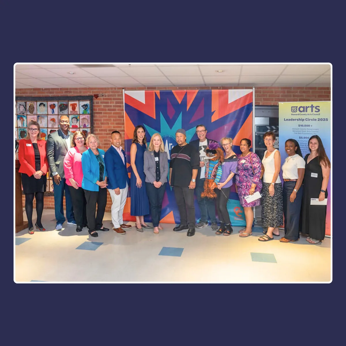 a group of people standing in front of a banner