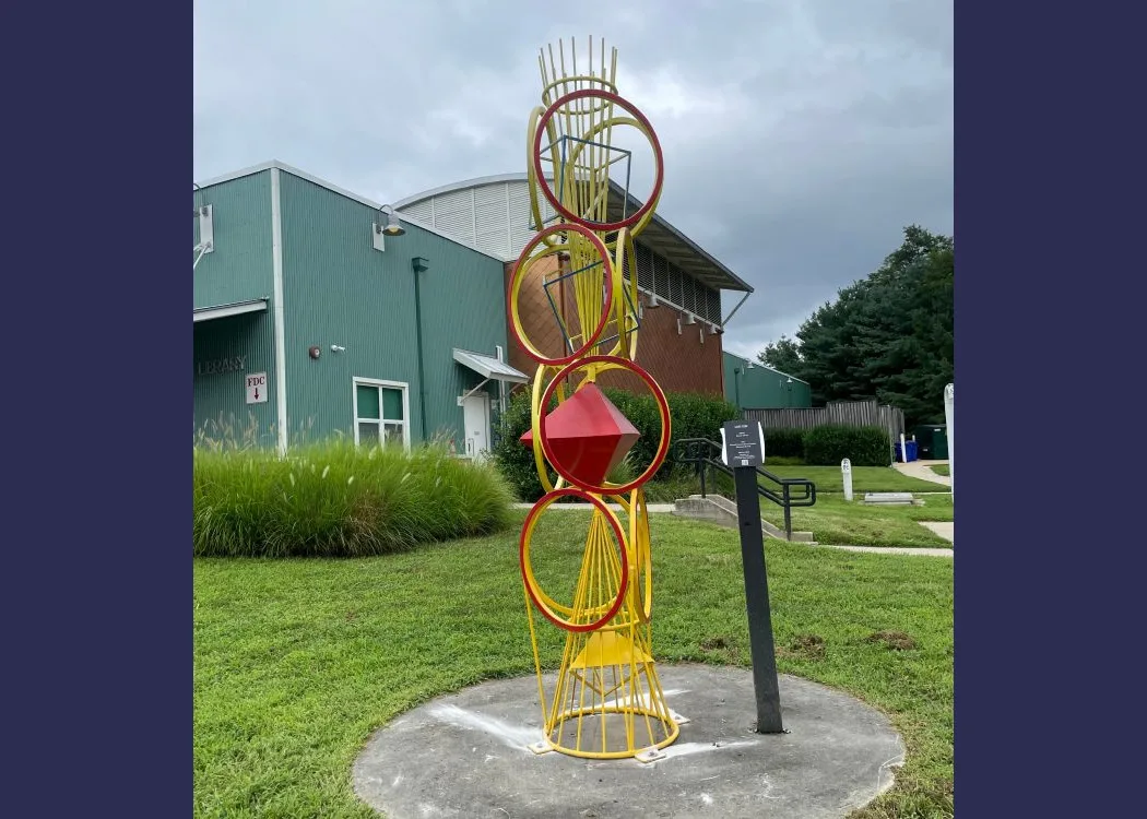 a geometric abstract sculpture consisting of concentric circles and diamonds stacked like a totem pole