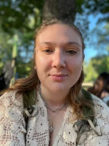 Portrait of a woman in front of trees